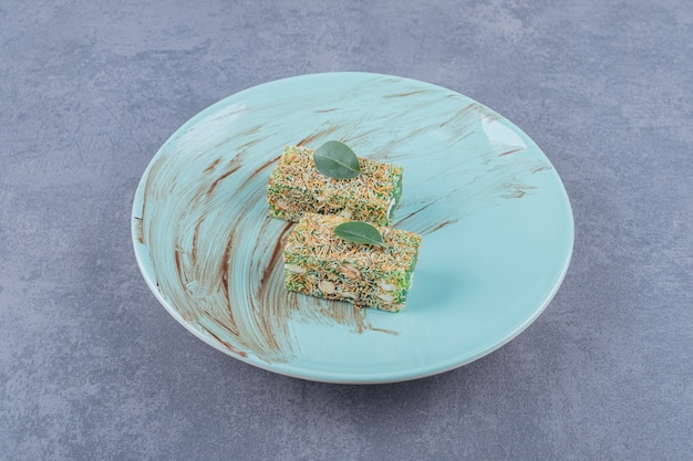 Free photo turkish delight rahat lokum with hazelnuts on green plate.