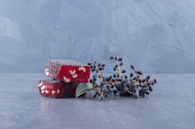 Turkish delight rahat lokum with pistachios on grey background.