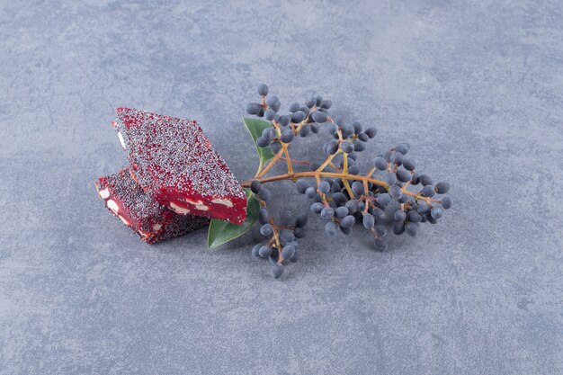 Turkish delight rahat lokum with pistachios on grey background.