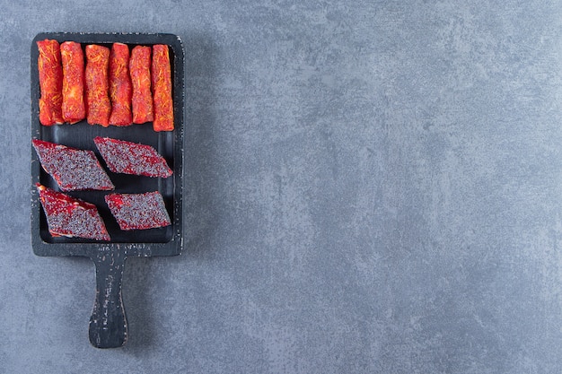 Turkish delights on a board , on the marble background.