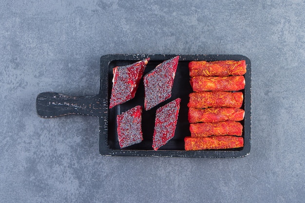 Free photo turkish delights on a board on the marble surface