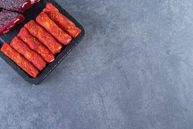 Turkish delights on a board on the marble surface