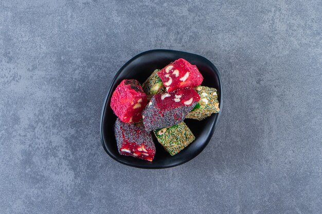 Turkish delights in a bowl, on the marble surface