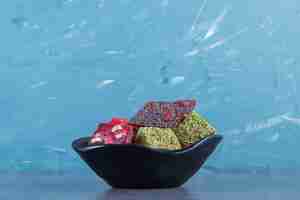 Free photo turkish delights in a bowl, on the marble surface