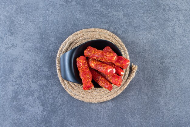 Turkish delights in a bowl on a trivet, on the marble surface