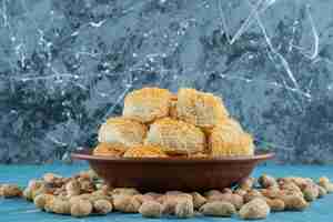 Free photo turkish delights with peanut nuts on a dark wooden plate.