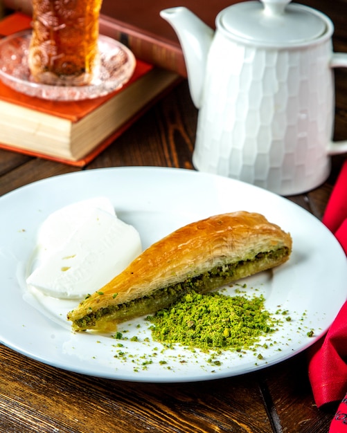 Turkish dessert kunefe  with ice- cream  pistachos  side view