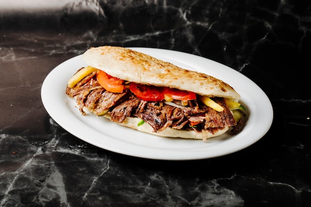 Turkish doner in tandir bread inside white plate.