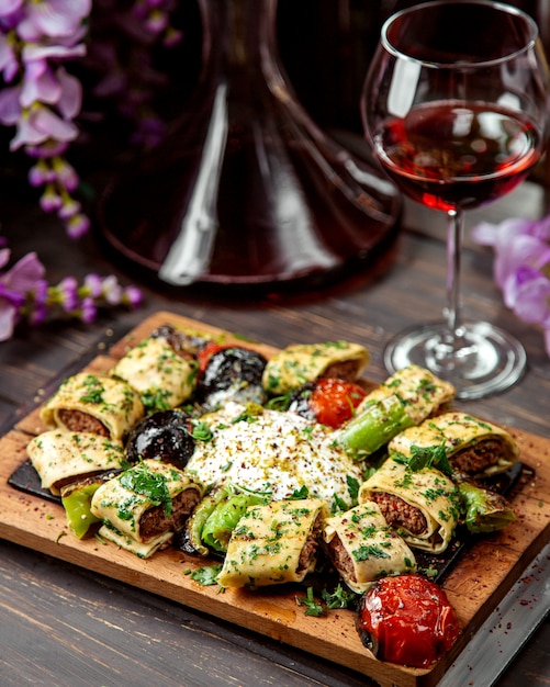 Turkish kebab wrapped in flatbread served with grilled vegetables and yogurt