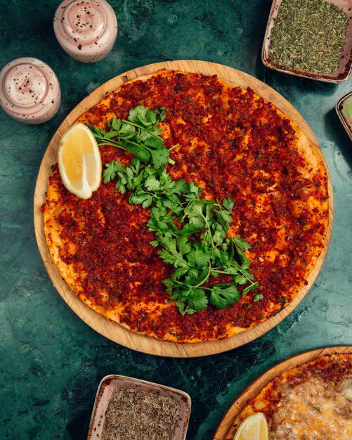 Turkish lahmacun with stuffings, lemon and chopped parsley.