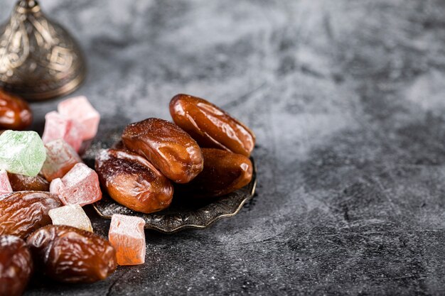 Turkish lokum with oriental dates inside an ethnic style saucer