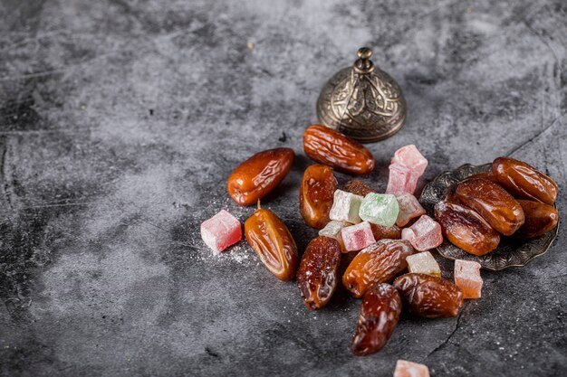 Turkish lokum with oriental dates on a stone table