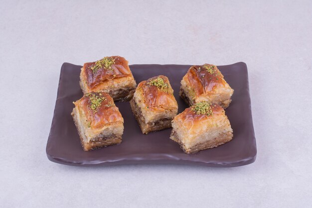 Turkish pakhlava on a black ceramic platter