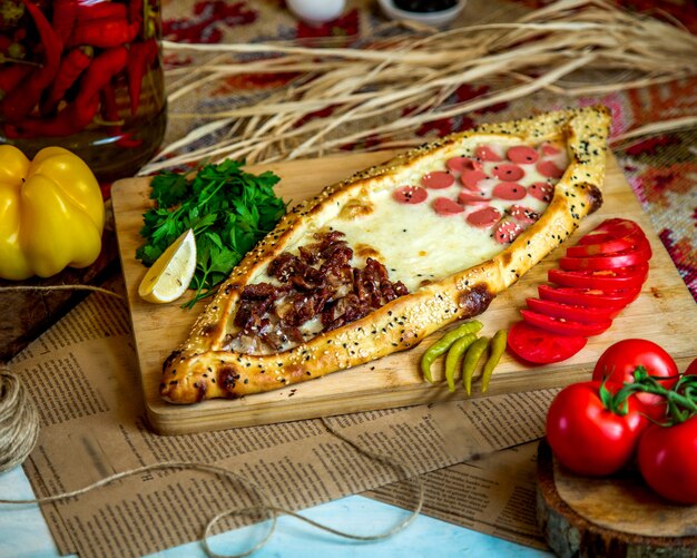 Turkish pide with meat sausage and cheese