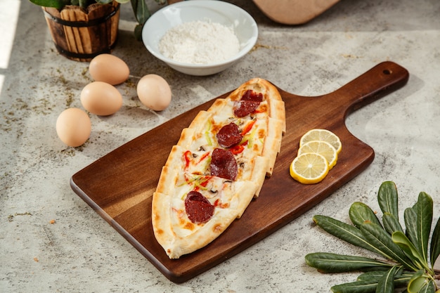 Turkish pide with salami bell peppers mushroom and cheese