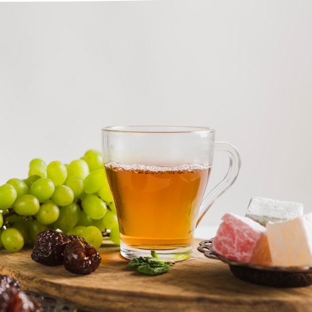 Turkish tea in mug with sweets and fruit