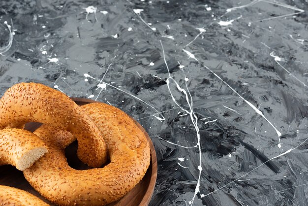 Turkish traditional bagel simit in a wooden plate on a marble background. 