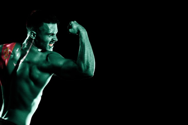 Turkmenistan flag on handsome young muscular man black background