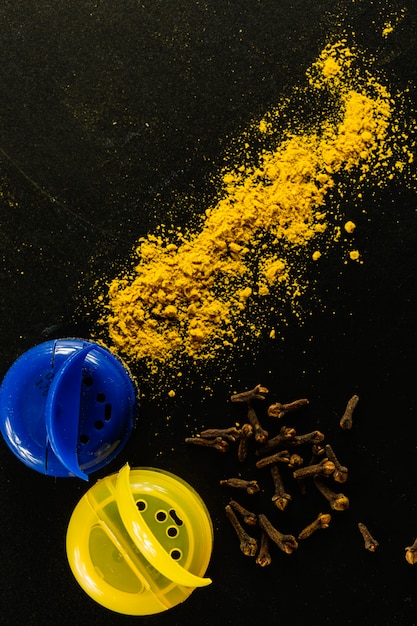 Turmeric and cloves near jars