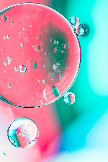 Бесплатное фото Бирюзовый и розовый абстрактный фон с пузырьками