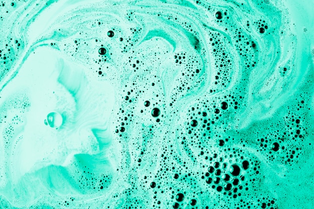 Turquoise bath bomb in the water