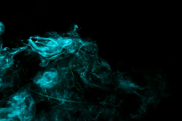 Turquoise creative smoke on black background