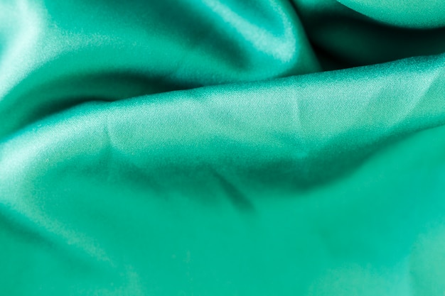 Free photo turquoise fabric material texture with copy space