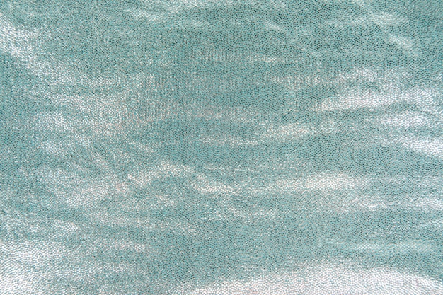 Turquoise shiny sequins textured in background