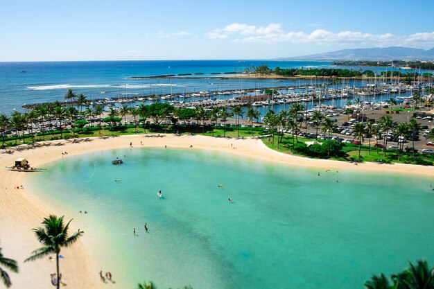 Turquoise water touches golden shores where people rest