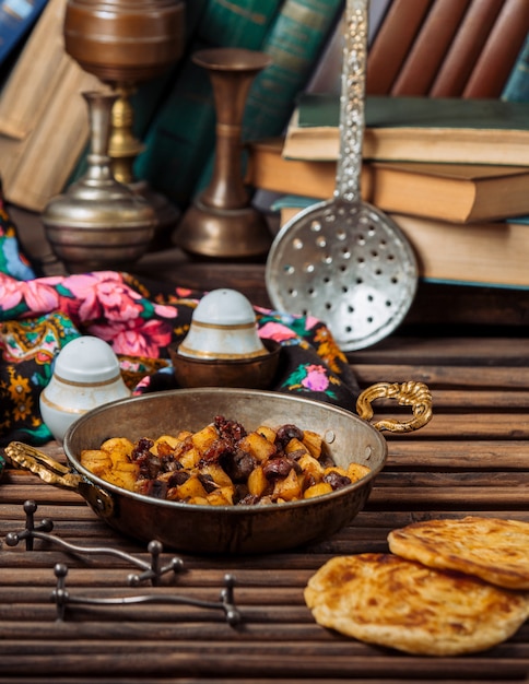 Free photo turshu govurma with dry fruits inside copper pan .image