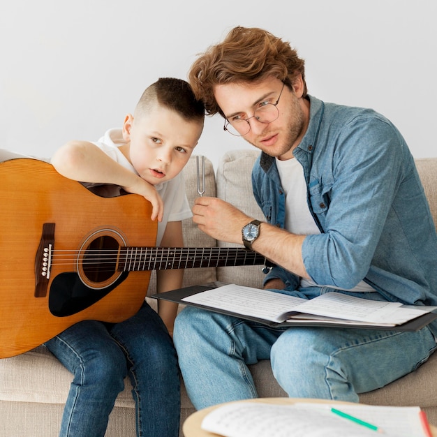 Tutor and boy listening to tuning fork