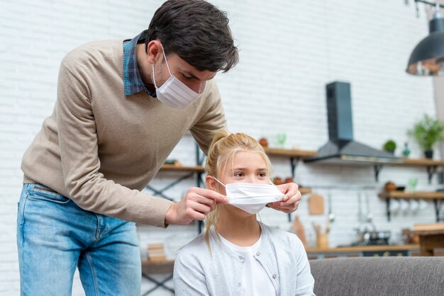 Tutor helping the girl to put her mask on