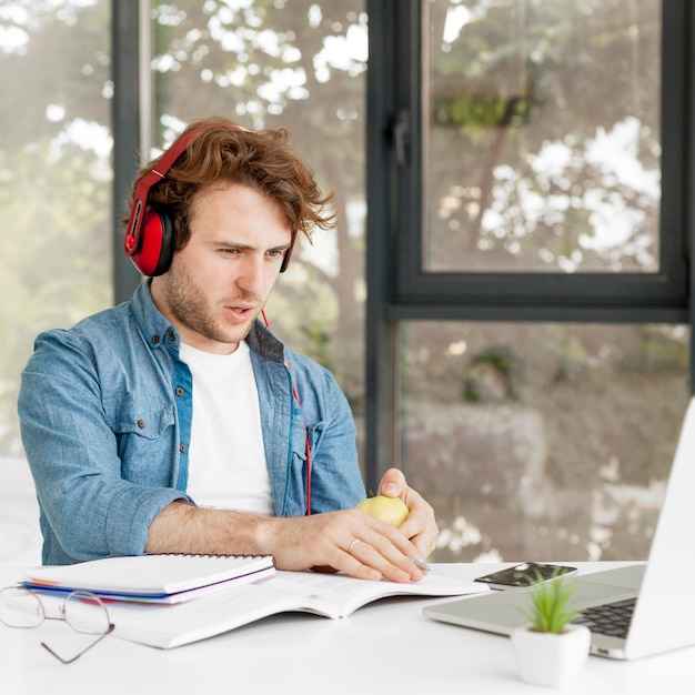 Free photo tutor at home wearing headphones