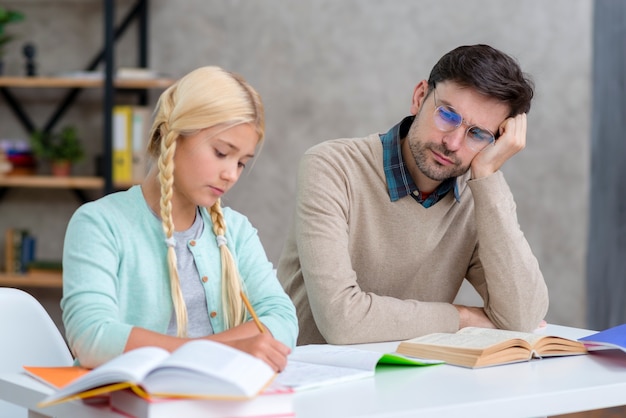 Tutor leaning on his hand alongside student medium shot