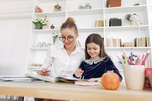 Tutor with litthe girl studying at home