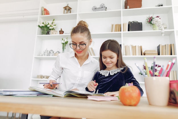 Tutor with litthe girl studying at home