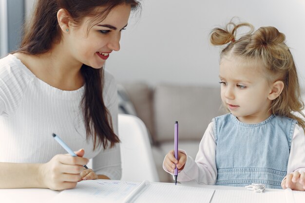 Tutor with litthe girl studying at home