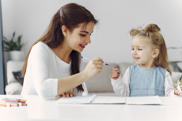 Tutor with litthe girl studying at home