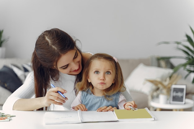 Tutor with litthe girl studying at home