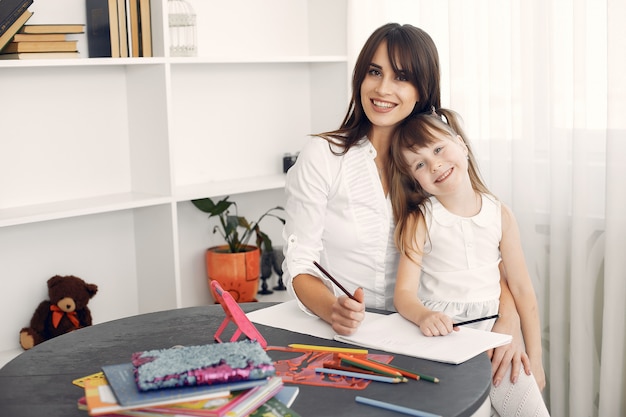 Tutor with litthe girl studying at home