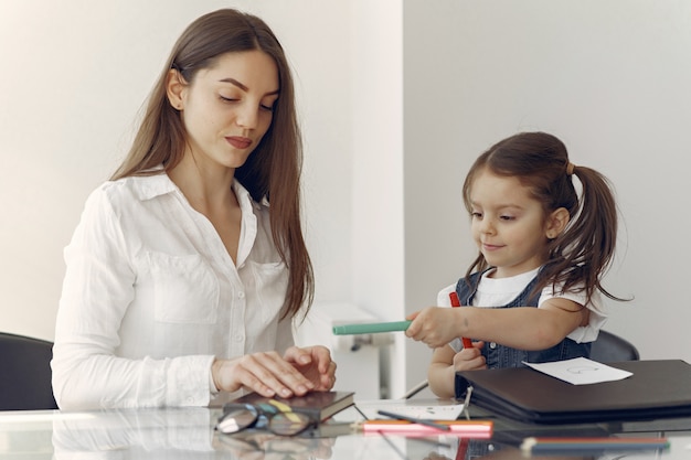 Tutor with litthe girl studying at home