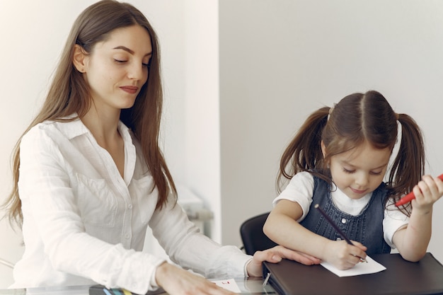 Tutor with litthe girl studying at home