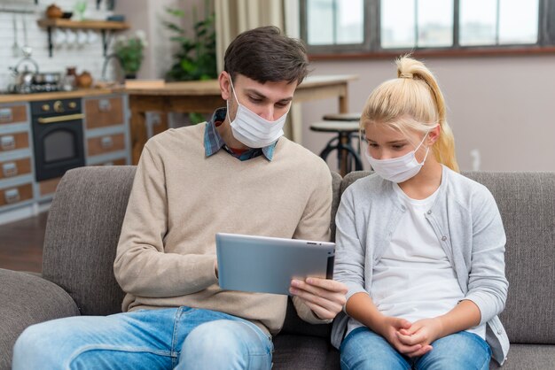 Tutor and young student using a tablet front view