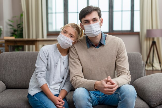 Tutor and young student wearing medical masks