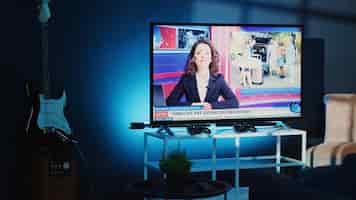 Free photo tv in apartment showing news broadcast