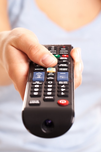 Free photo tv console in woman's hand