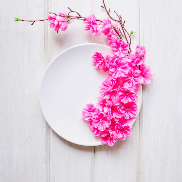 Twig and flowers on plate