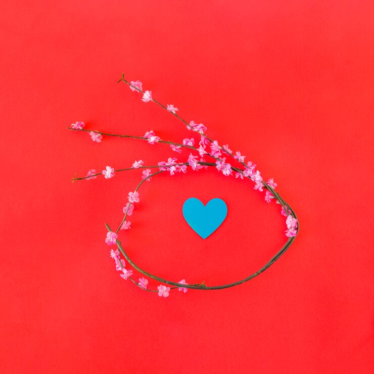 Free Photo twig with flowers in form of circle and paper heart