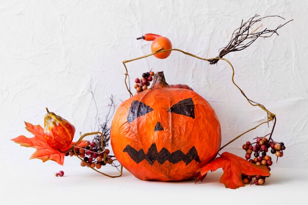 Twigs and berries near jack-o-lantern