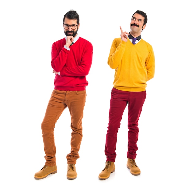 Free photo twin brothers thinking over white background